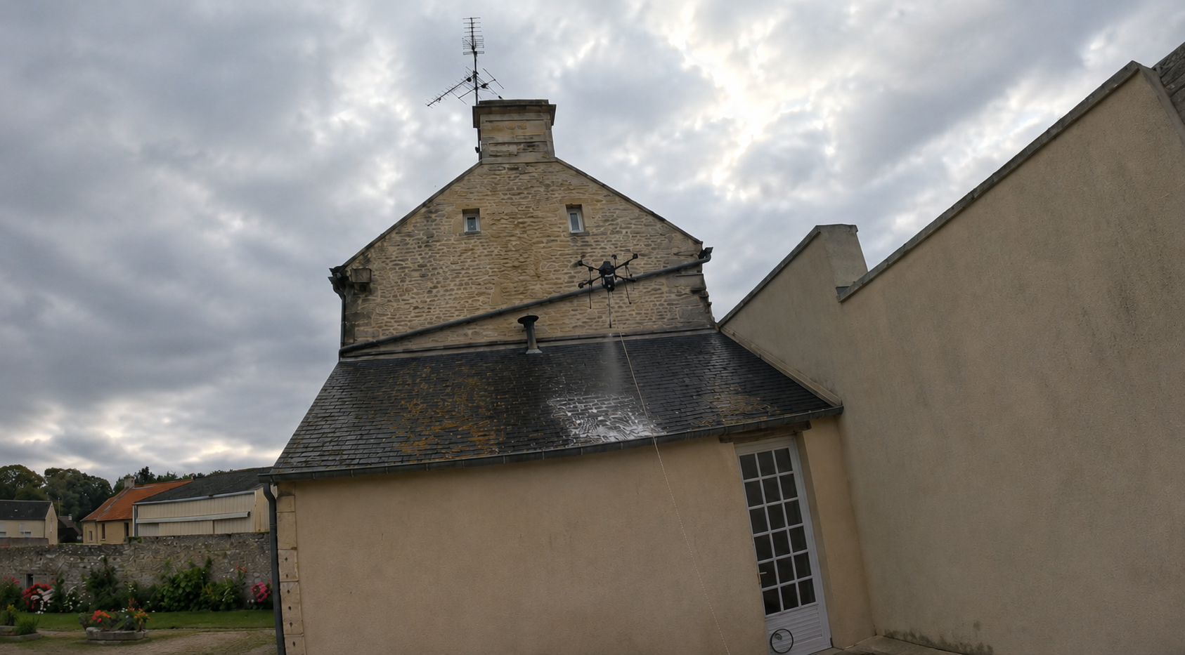 Traitement par drone d’une toiture en ardoise avec lichens à Banville